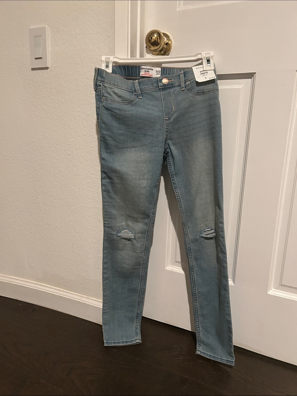 abercrombie kids faded blue skinny jeans with knee tears